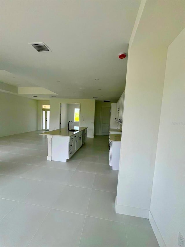 1043 Brenton Ave, Lehigh Acres, FL 33974 - hall featuring light tile patterned floors, a sink, and baseboards