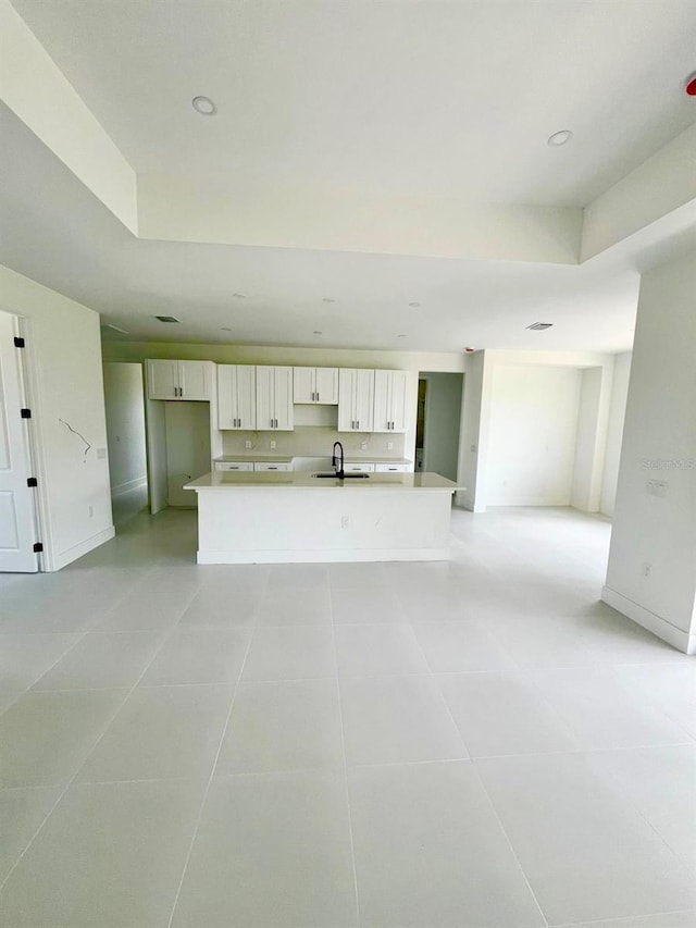 1043 Brenton Ave, Lehigh Acres, FL 33974 - unfurnished living room featuring a sink, light tile patterned flooring, recessed lighting, and baseboards