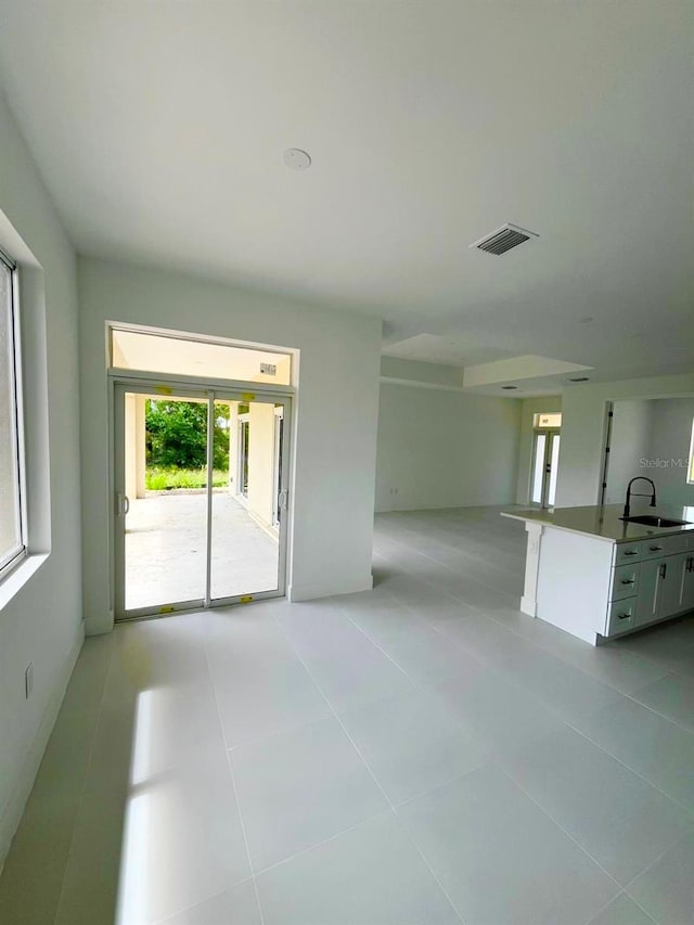 1043 Brenton Ave, Lehigh Acres, FL 33974 - unfurnished living room with a sink and light tile patterned floors