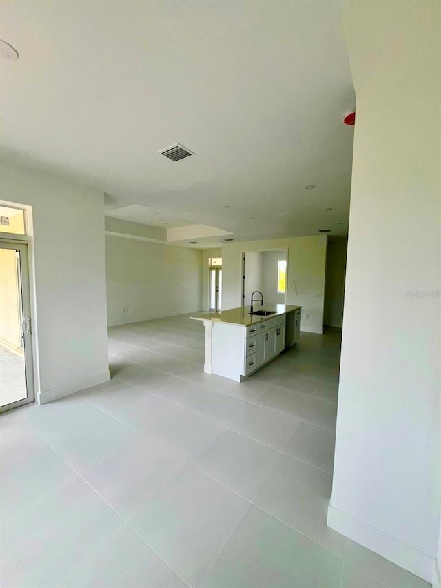 1043 Brenton Ave, Lehigh Acres, FL 33974 - spare room featuring a sink, light tile patterned flooring, and baseboards