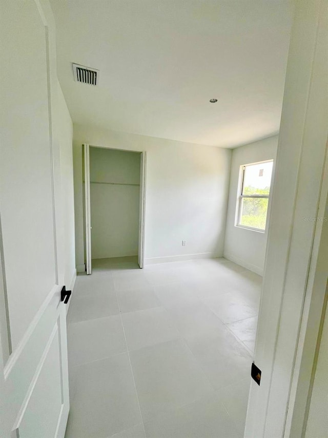 1043 Brenton Ave, Lehigh Acres, FL 33974 - unfurnished bedroom featuring baseboards and light tile patterned floors