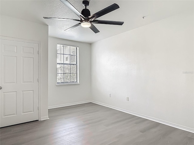 5550 E Michigan St Unit 2214, Orlando, FL 32822 - unfurnished bedroom with baseboards, a ceiling fan, and wood finished floors
