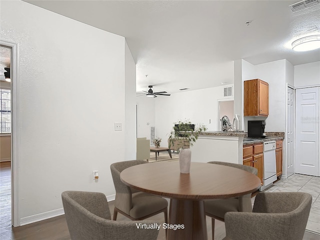 5550 E Michigan St Unit 2214, Orlando, FL 32822 - dining room featuring visible vents, ceiling fan, and baseboards