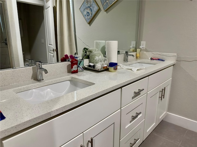 1804 Hudson Ct, Poinciana, FL 34759 - bathroom with a sink, tile patterned floors, double vanity, and baseboards