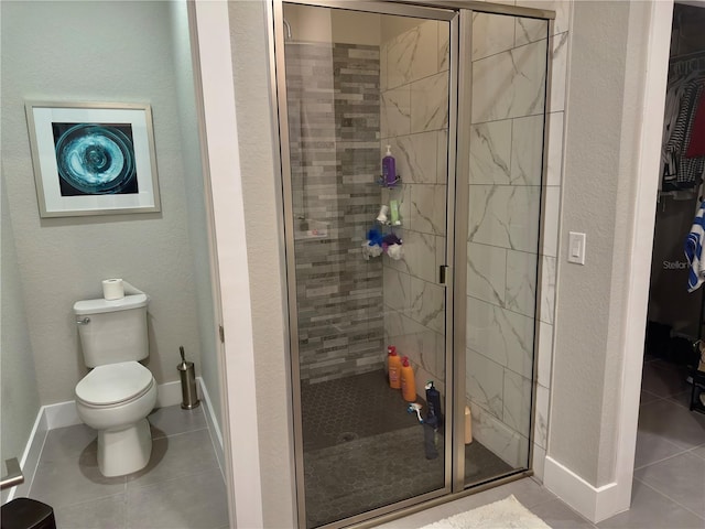1804 Hudson Ct, Poinciana, FL 34759 - bathroom featuring baseboards, a stall shower, a spacious closet, tile patterned flooring, and toilet