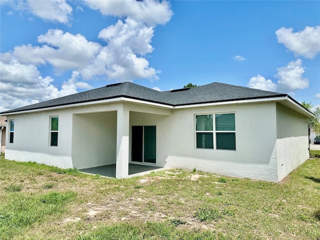 1804 Hudson Ct, Poinciana, FL 34759 - back of house with a patio area, stucco siding, and a lawn