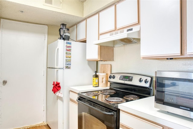 4105 Tropical Isle Blvd Unit 231, Kissimmee, FL 34741 - kitchen featuring light countertops, white cabinets, under cabinet range hood, range with electric stovetop, and visible vents