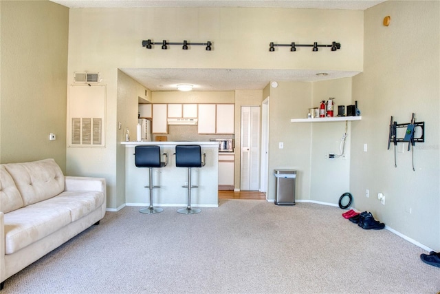 4105 Tropical Isle Blvd Unit 231, Kissimmee, FL 34741 - living room with light colored carpet, baseboards, and visible vents