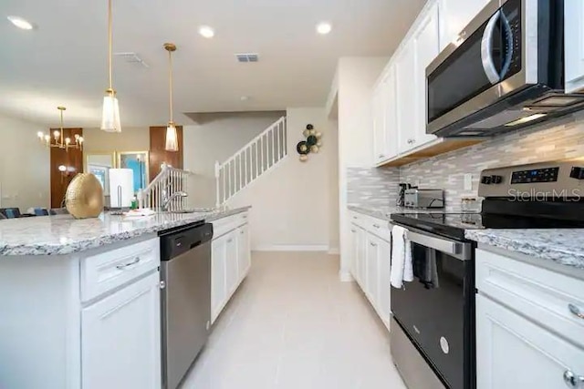 3834 Lana Ave, Davenport, FL 33897 - kitchen with stainless steel appliances, visible vents, white cabinetry, and backsplash