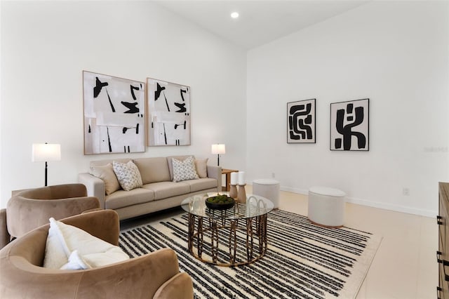 living area featuring baseboards and recessed lighting