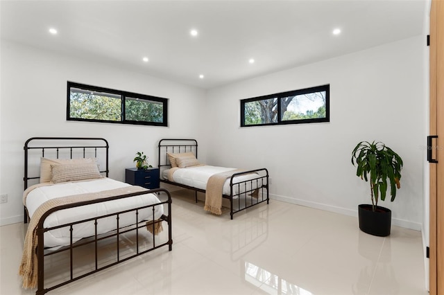 tiled bedroom featuring recessed lighting and baseboards