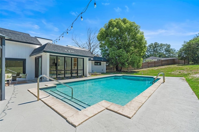 pool with an exterior structure, a yard, an outdoor structure, a patio, and fence