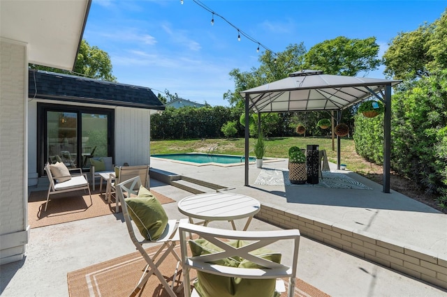 view of patio / terrace with an outdoor pool and a gazebo