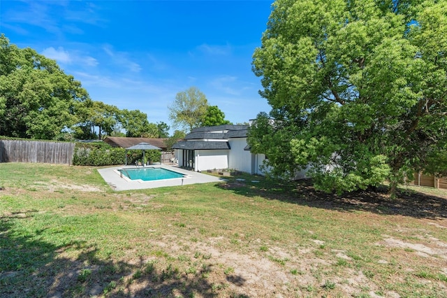 view of pool featuring fence, a fenced in pool, a patio, and a lawn