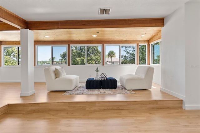 sitting room with ornate columns, visible vents, baseboards, and wood finished floors