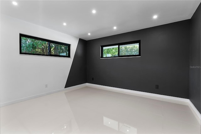 unfurnished room with tile patterned floors and recessed lighting