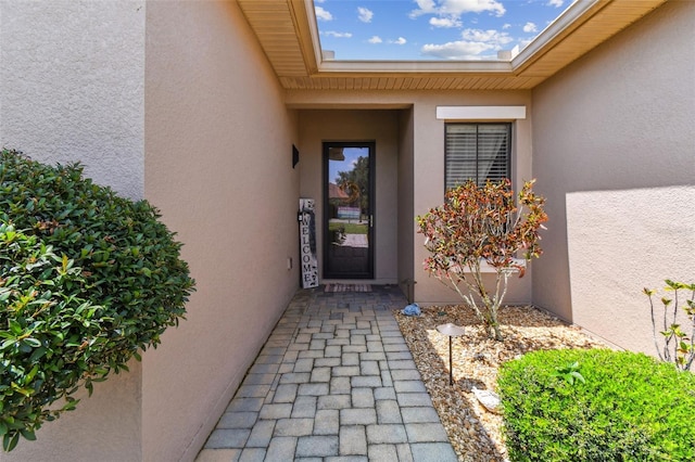 doorway to property with stucco siding