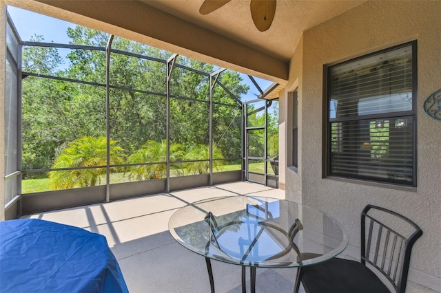 sunroom / solarium featuring ceiling fan