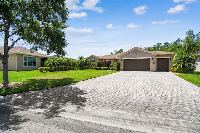 ranch-style home with a front yard, decorative driveway, an attached garage, and stucco siding