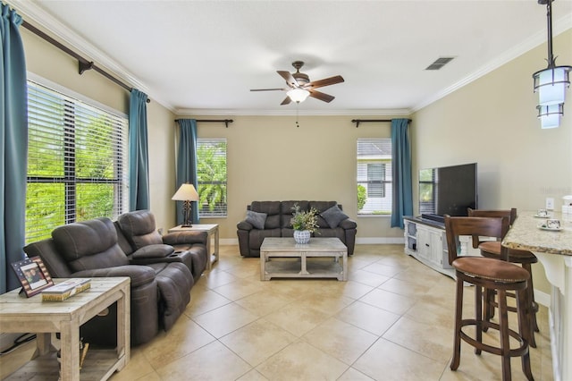living room featuring visible vents, ornamental molding, a healthy amount of sunlight, and ceiling fan
