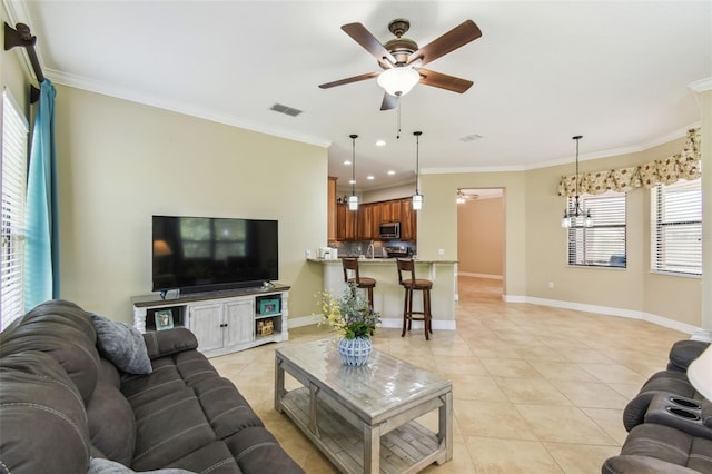living room featuring visible vents, ornamental molding, ceiling fan, and light tile patterned flooring
