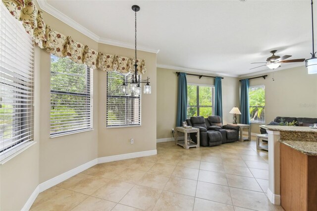 living area with light tile patterned flooring, crown molding, a ceiling fan, and baseboards