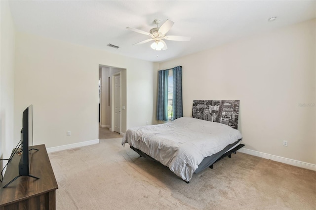 carpeted bedroom with baseboards, visible vents, and ceiling fan