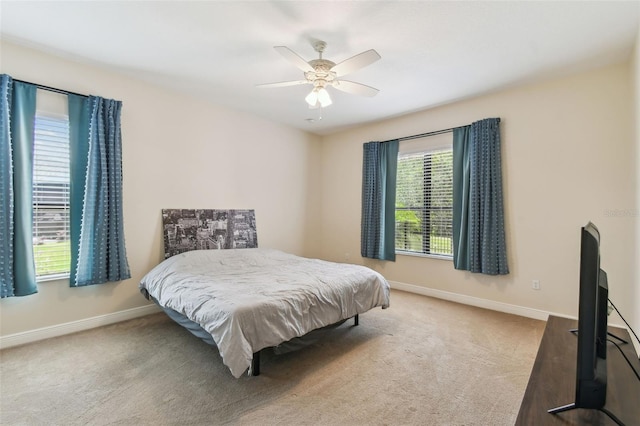 bedroom with baseboards, a ceiling fan, and carpet