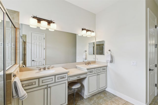full bathroom featuring double vanity, tile patterned flooring, a stall shower, and a sink