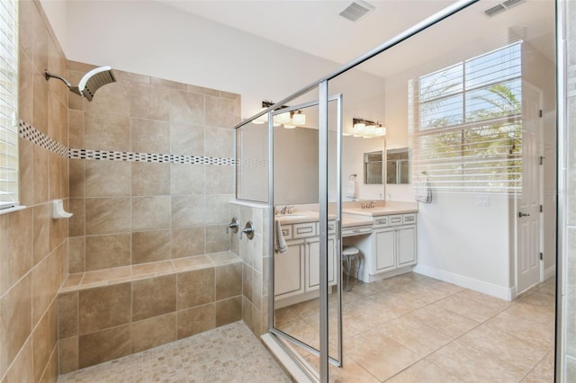 full bathroom with a sink, a stall shower, and visible vents