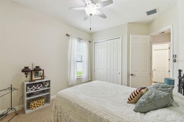 bedroom with visible vents, baseboards, a closet, carpet, and a ceiling fan