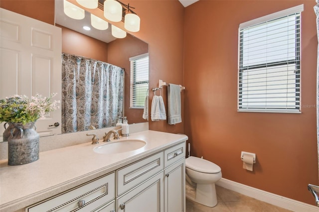 bathroom with vanity, curtained shower, tile patterned floors, toilet, and baseboards