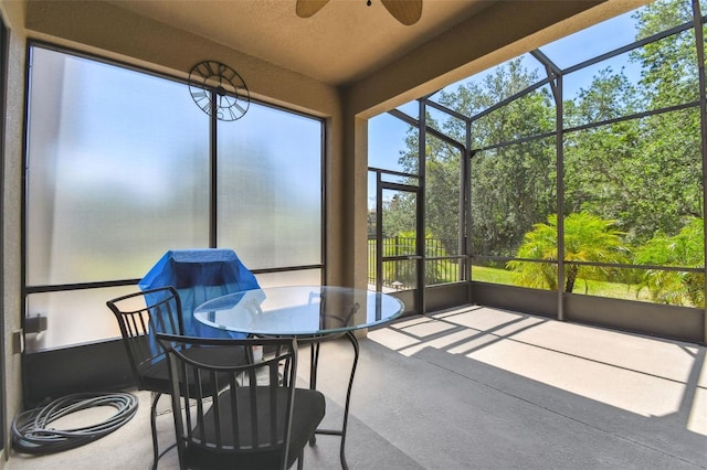 sunroom / solarium featuring ceiling fan