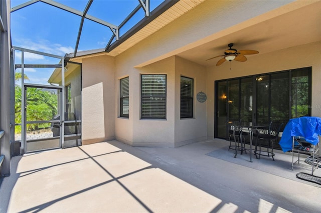 view of patio / terrace featuring ceiling fan and a lanai