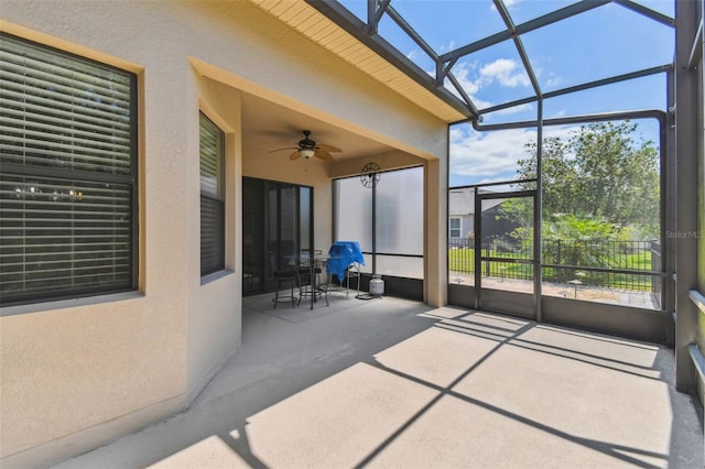 sunroom with a ceiling fan and plenty of natural light