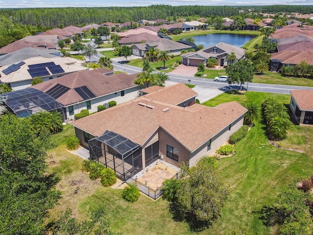 birds eye view of property with a water view and a residential view