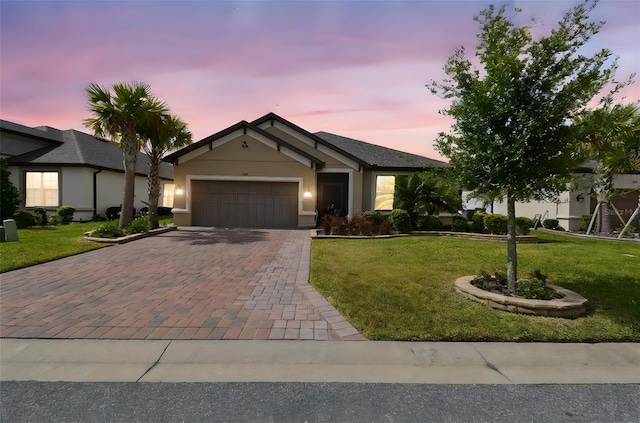 204 Bella Cortina Dr, Kissimmee, FL 34759 - single story home with decorative driveway, a garage, a front yard, and stucco siding
