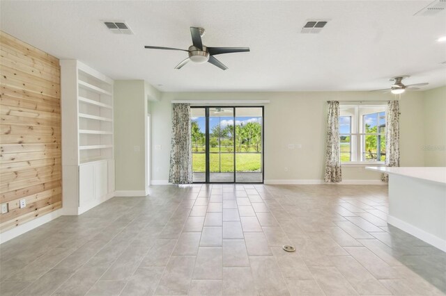 204 Bella Cortina Dr, Kissimmee, FL 34759 - spare room with a ceiling fan, baseboards, built in features, and light tile patterned floors