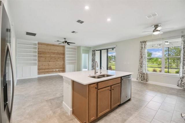 204 Bella Cortina Dr, Kissimmee, FL 34759 - kitchen featuring a sink, ceiling fan, appliances with stainless steel finishes, brown cabinets, and built in features