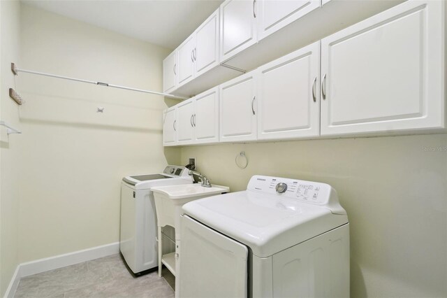 204 Bella Cortina Dr, Kissimmee, FL 34759 - washroom featuring washer and dryer, cabinet space, and baseboards