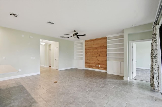 204 Bella Cortina Dr, Kissimmee, FL 34759 - spare room with built in shelves, a ceiling fan, and baseboards