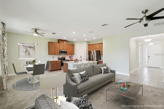 204 Bella Cortina Dr, Kissimmee, FL 34759 - living room with ceiling fan, light tile patterned floors, baseboards, and recessed lighting