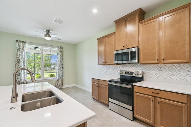 204 Bella Cortina Dr, Kissimmee, FL 34759 - kitchen with stainless steel appliances, a sink, light countertops, and backsplash