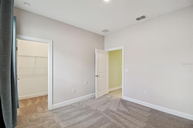 204 Bella Cortina Dr, Kissimmee, FL 34759 - unfurnished bedroom featuring carpet flooring, a spacious closet, baseboards, and a closet