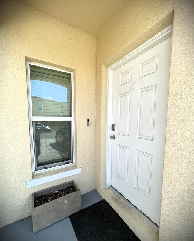 4871 Coral Castle Dr, Kissimmee, FL 34746 - view of exterior entry with stucco siding