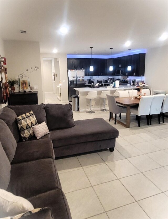 4871 Coral Castle Dr, Kissimmee, FL 34746 - living room featuring visible vents and light tile patterned floors