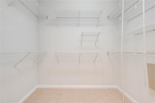 walk in closet with tile patterned flooring