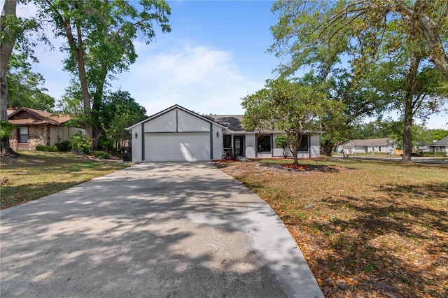 mid-century modern home featuring concrete driveway, a front yard, and an attached garage