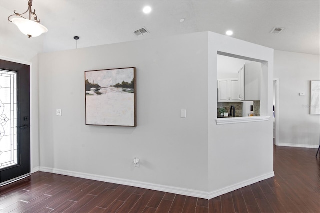 foyer with recessed lighting, visible vents, baseboards, and wood finished floors