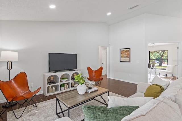 living room featuring visible vents, baseboards, recessed lighting, wood finished floors, and high vaulted ceiling